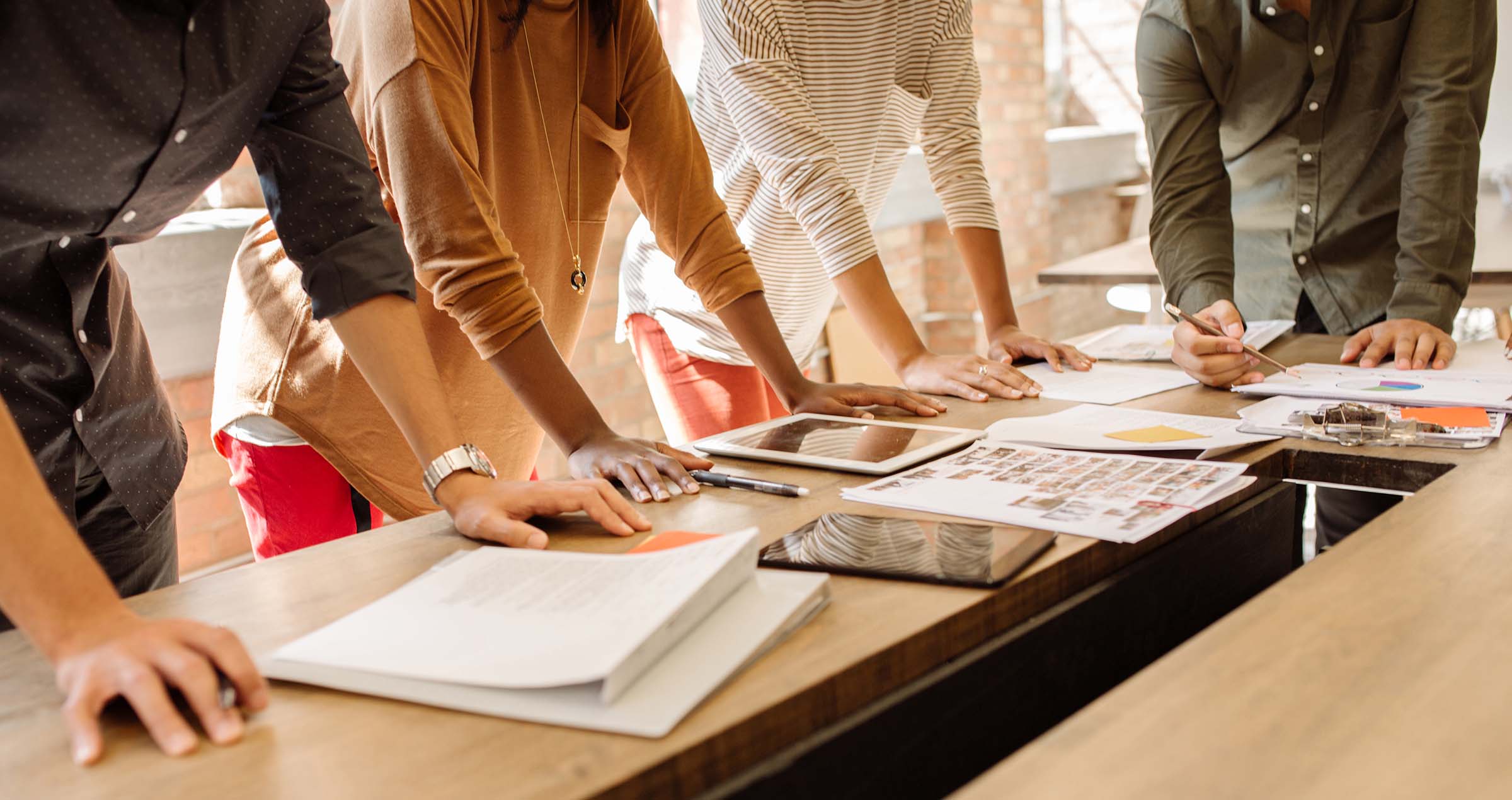 Entrepreneurs standing around a table